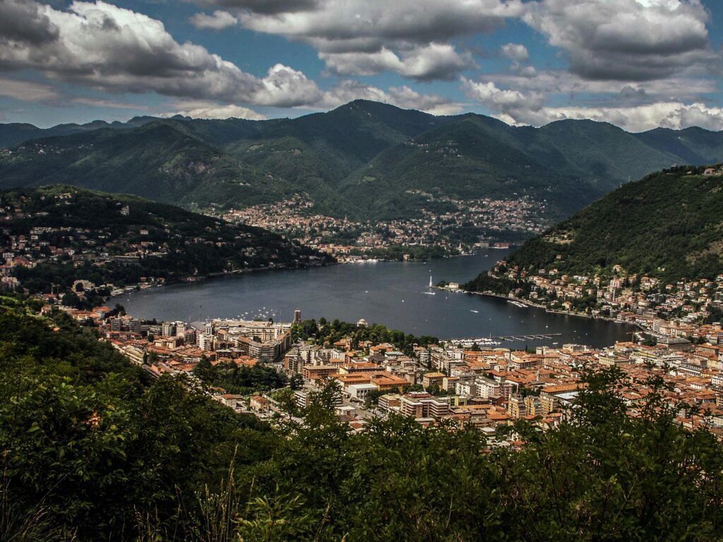 A breathtaking aerial vista of Lake Como nestled in the lush Lombardy mountains.