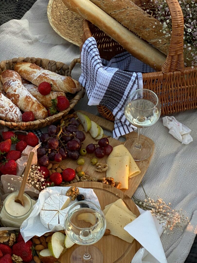 Lavish picnic setting with wine, cheese, fresh bread, and fruits in Sochi, Russia.